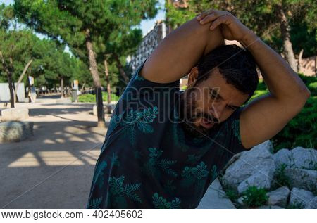 Strong Build Man In Short Sleeve T-shirt Doing Exercise