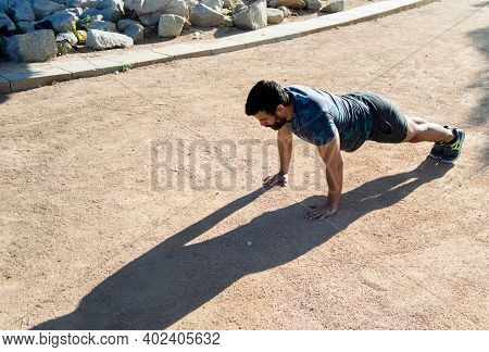 Strong Build Man In Short Sleeve T-shirt Doing Exercise