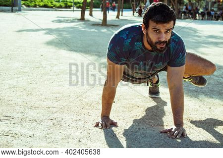 Strong Build Man In Short Sleeve T-shirt Doing Exercise