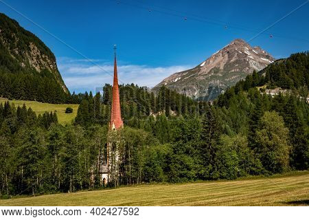 Rural Alpine Landscape With Church Of St. Martin In Pockhorn Near Heiligenblut In Hohe Tauern Nation