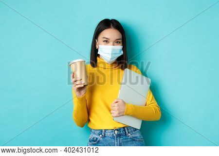 Covid, Pandemic And Social Distancing Concept. Stylish Asian Woman Wearing Medical Mask, Holding Cup