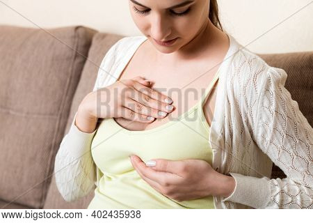 Pregnant Girl Checks Her Breasts. Prevention Of Breast Cancer