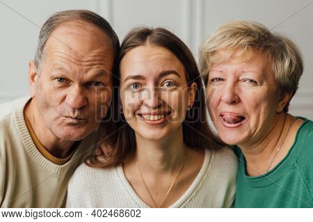 Close Up Portrait Of Family With Elderly Mature Woman, Man And Millennial Daughter