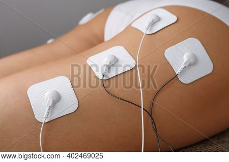 Myostimulation Electrodes On The Buttocks And Legs Of A Woman In A Beauty Salon.