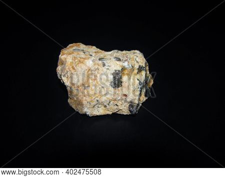 Streaks Of Pegmatite In The Mineral. Beige Stone With Gray Streaks.