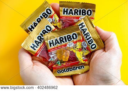 Tambov, Russian Federation - January 06, 2021 Woman Palms Full Of Small Packs Of Haribo Bears Gummy 