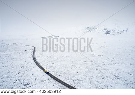Aerial View Of A82 Road Through Rannoch Moor And Black Mount Covered In Snow During Winter