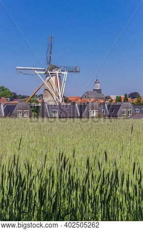 Windmill, Houses And Church Tower In The Historic Town Ootmarsum, Netherlands