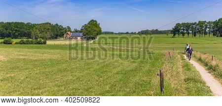 Ootmarsum, Netherlands - May 26, 2020: Panorama Of Women Hiking In The Hills Near Ootmarsum, Netherl