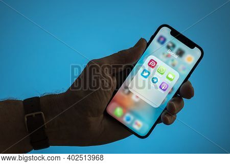 Morgantown, Wv - 9 January 2021: Male Hand Holding Phone With Icons For Parler And Twitter With Disp