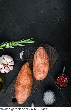Sweet Potato Or Batat With Herbs And Spices On Black Background, Top View With Space For Text.
