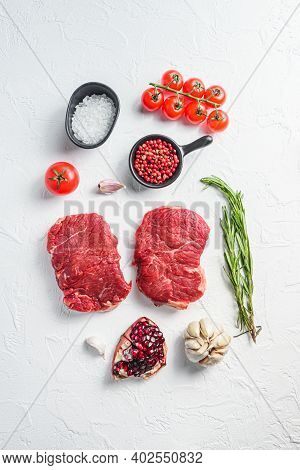 Raw Rumpsteak, Farm Beef Meat With Seasonings, Rosemary, Garlic. White Textured Background. Top View