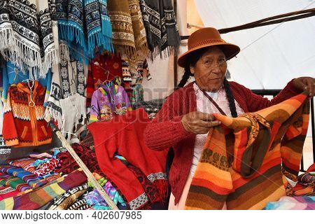 Pisac, Peru - September 04, 2016: Unidentified People Trade Colourful Goods In Marketplace In Pisac,