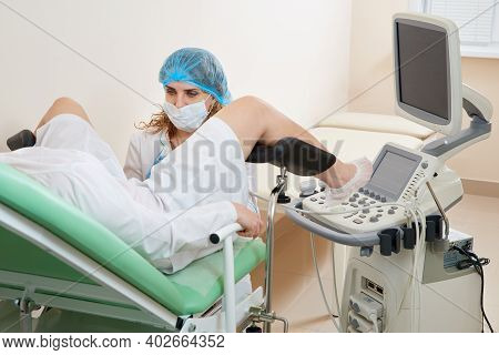Gynaecologist Examining A Patient Sitting On Gynecological Chair