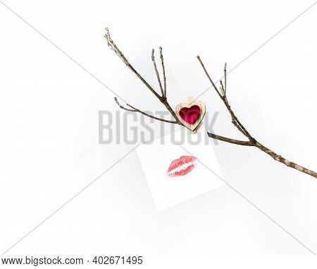 White Card With Lip Print Hanging On A Bare Winter Tree Branch Pinned With A Clothespin With A Red H