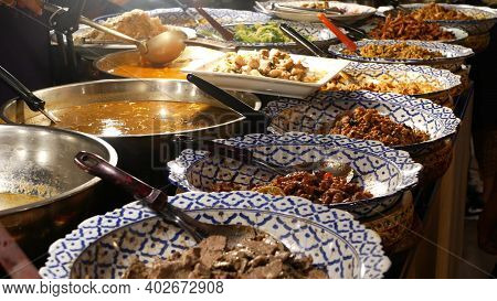 Bowls With Various Asian Dishes On Stall. Bowls Of Assorted Traditional Thai Dishes Placed On Stall 