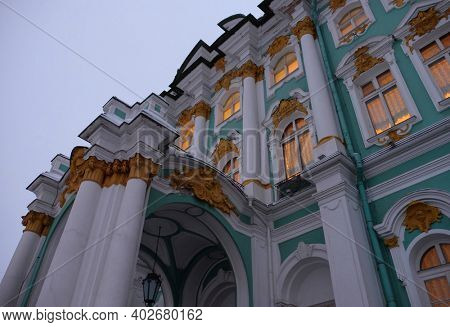 Hermitage Museum or Winter palace in Saint-Petersburg. Burning windows on a twilight day.