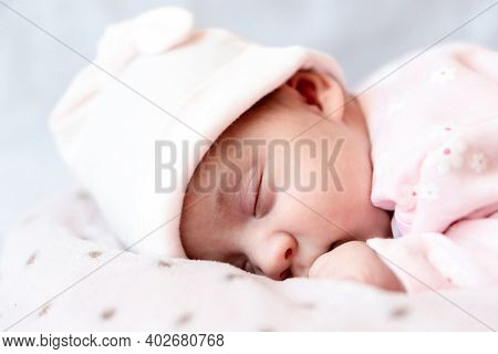 Childhood, Care, Motherhood, Health Concepts - Close Up Little Peace Calm Newborn Baby Girl In Pink 