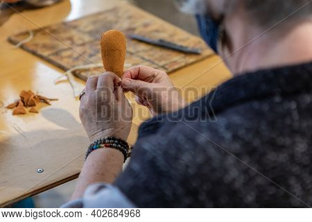 Close Up Of From Above Of An Elderly Woman With Covid Protective Face Mask Working On The Head Of A 