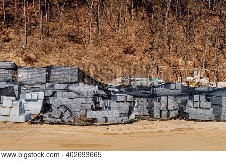 Stacks Of Concrete Blocks Covered With Black Mesh At New Construction Site