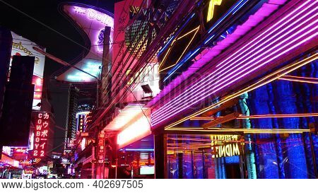Bangkok, Thailand, 13 July 2019: Vivid Neon Signs Glowing On Soi Cowboy Street. Nightlife In Erotic 