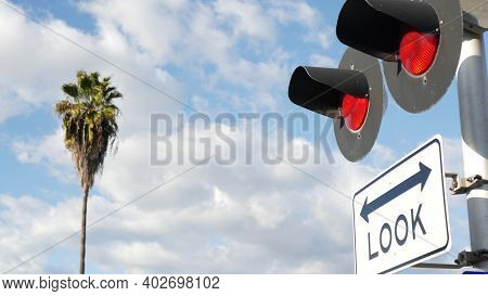 Level Crossing Warning Signal In Usa. Crossbuck Notice And Red Traffic Light On Rail Road Intersecti