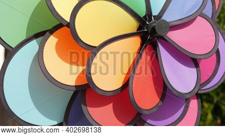 Colorful Pinwheel Spinning, Weather Wind Vane, Garden Decoration In Usa. Rainbow Symbol Of Childhood