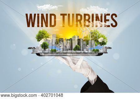 Waiter serving eco city with WIND TURBINES inscription, renewabke energy concept