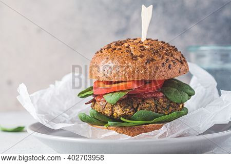 Vegan Lentil Burger With Baked Sweet Potato, Tomato Sauce And Fresh Vegetables On A Gray Plate. Vega