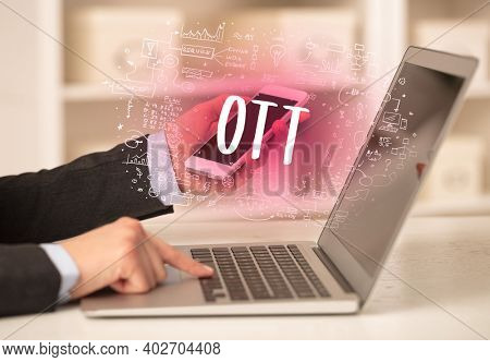 hand working on new modern computer with OTT abbreviation, modern technology concept