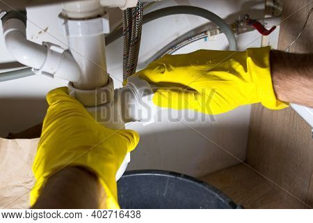 Cleaning The Sink Siphon In The Kitchen