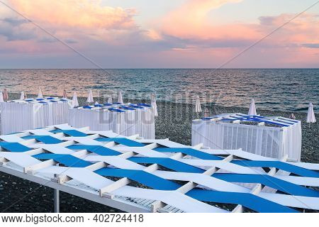 Beach Canopies With Sun Loungers And Umbrellas By The Sea