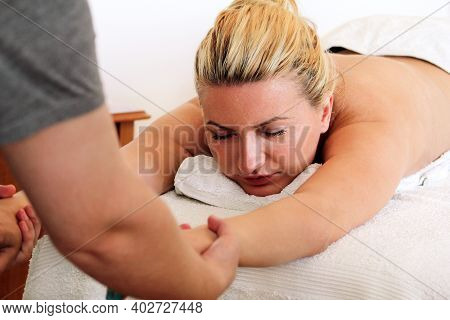 Massage Relax Studio. Stretching Massage. Men Hand Stretching Massage The Girl. Body Care. Spa Body 