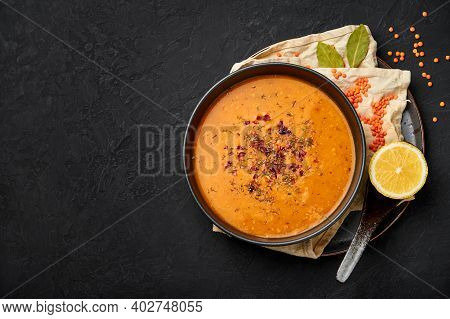 Ezogelin Soup In Black Bowl On Dark Slate Table Top. Turkish Cuisine Traditional Dish With Red Lenti