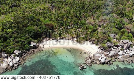 Bungalows And Green Coconut Palms On Tropical Beach. Cottages On Sandy Shore Of Diving And Snorkelin