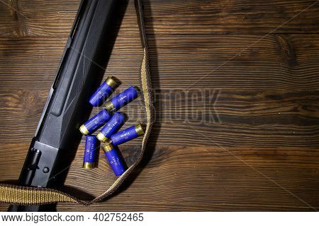 Shotgun On Wooden Background Text For Inscription