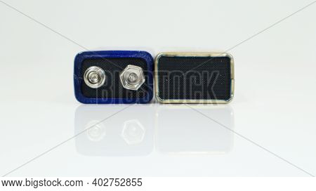 Two Blue Used Pp3 Batteries On A White Background With Reflection. Main Battery For Personal Power S