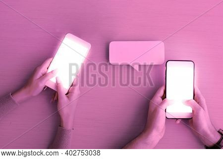 Blank text message screens with hands holding mobile phones