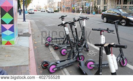 San Diego, California Usa - 4 Jan 2020: Row Of Ride Sharing Electric Scooters Parked On Street In Ga