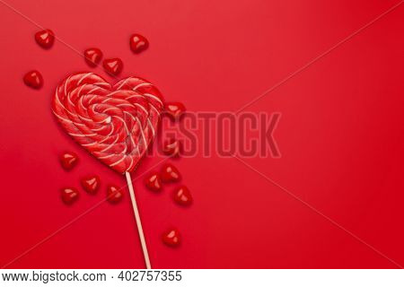 Valentines day greeting card template. Heart candy sweets over red background. Top view flat lay with copy space