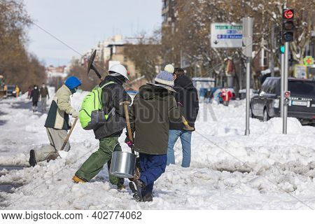 Madrid, Spain - January 10, 2021: Citizens And Neighbors Of Madrid, Collaborating And Cleaning The S