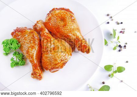 Raw Chicken Legs With Herbs And Spices On White Background.marinated Chicken Dramstick On A White Pl