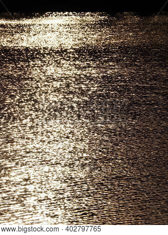 Abstract Background Texture, Golden Glitter Water On A Lake