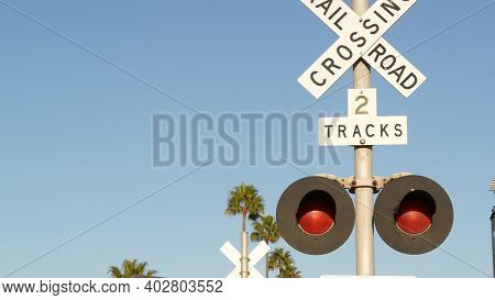 Level Crossing Warning Signal In Usa. Crossbuck Notice And Red Traffic Light On Rail Road Intersecti