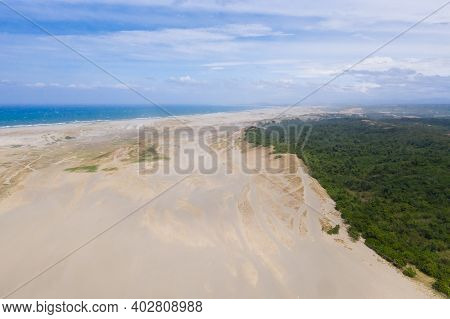 The Sand Dunes Of Paoay, Ilocos Norte, Philippines. Landscape With Trees And Sand Hills Near The Oce