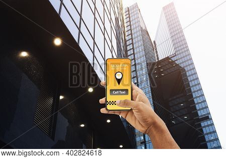 Best Taxi Service. Black Male Hand Holding Smartphone With Opened App For Cab Booking Over Urban Sky