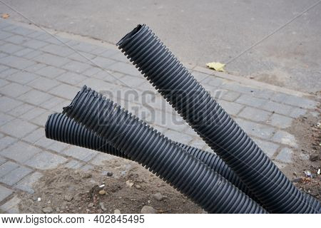 Pipes Protrude From The Pavement, Unfinished Construction Of Underground Corrugated Pipes, Unburied 