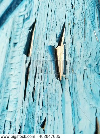 Close-up Old Blue Cracked Paint. The Texture Of The Old Emerald Paint With Cracks. Dried In The Sun 