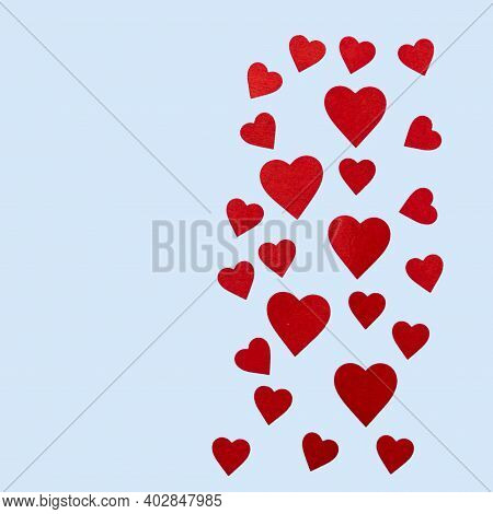 Red And Pink Felt Hearts Of Different Sizes Are On A Blue Background As A Decoration Or A Design Car