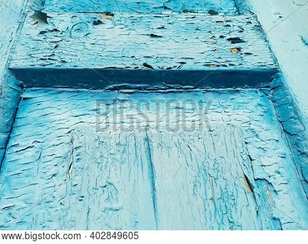 Close-up Old Blue Cracked Paint. The Texture Of The Old Emerald Paint With Cracks. Dried In The Sun 